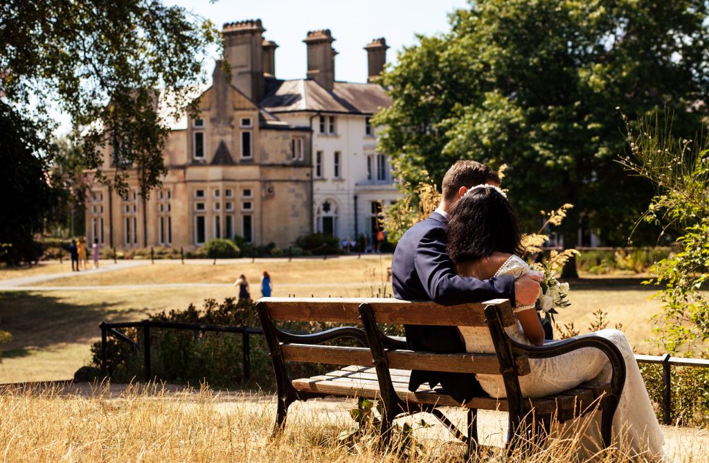 Bride and groom sitting on a bench