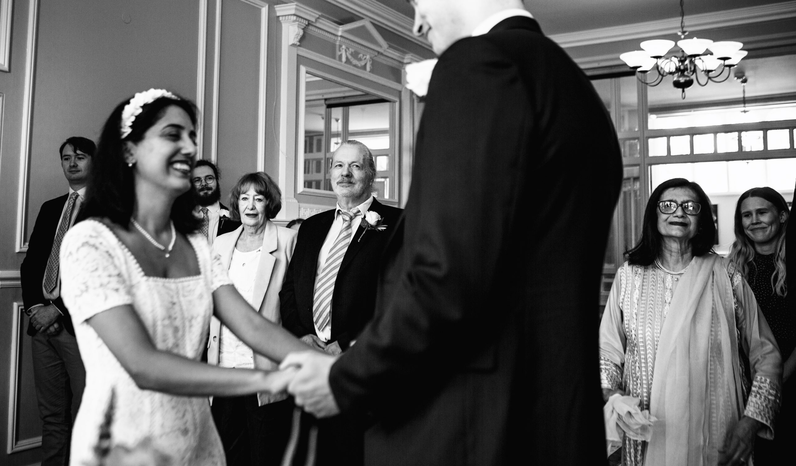 Bride and groom standing at the altar holding hands