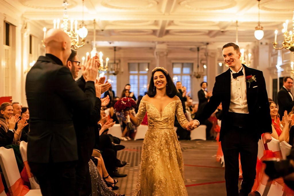 Bride-and-groom-smiling-at-the-guests.