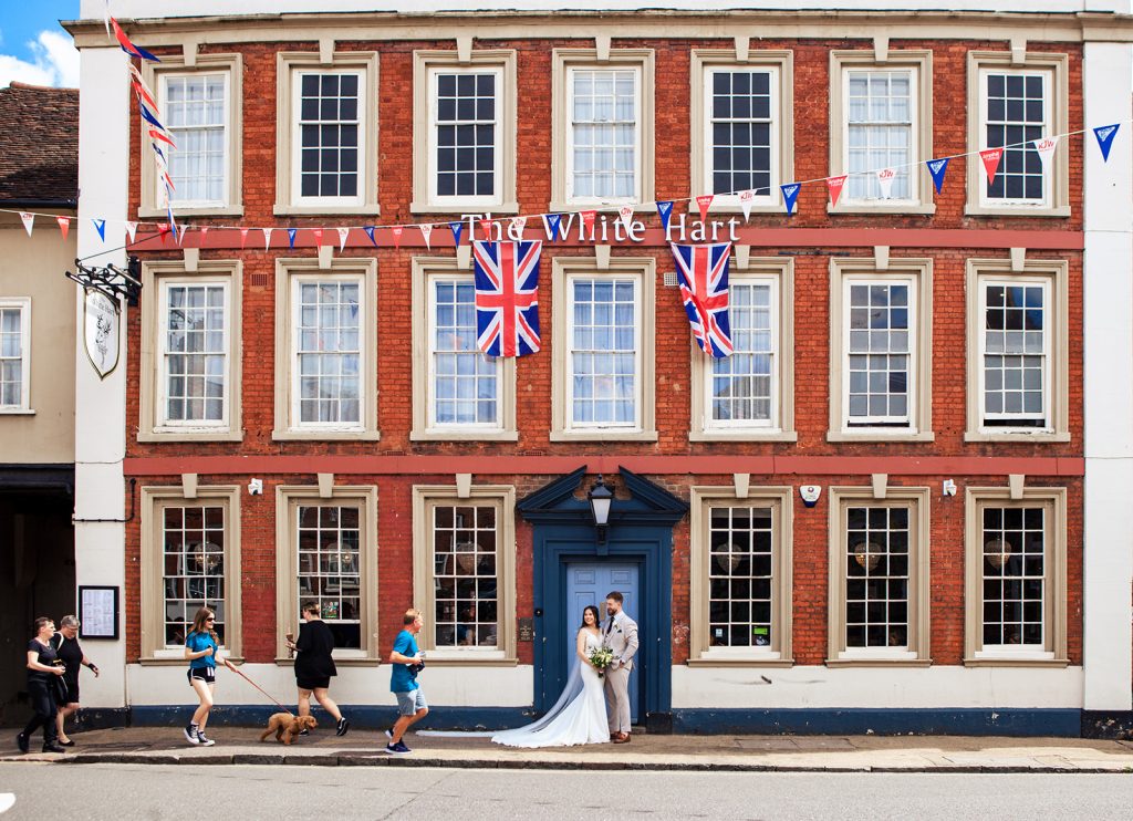 Wedding couple looking at pedestrians