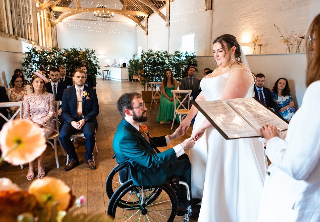 bride and groom holding hands at the barn alswick