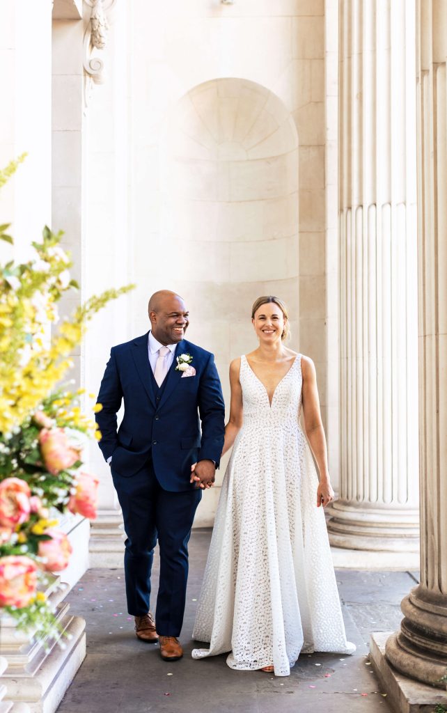 bride and groom walking marylebone town hall