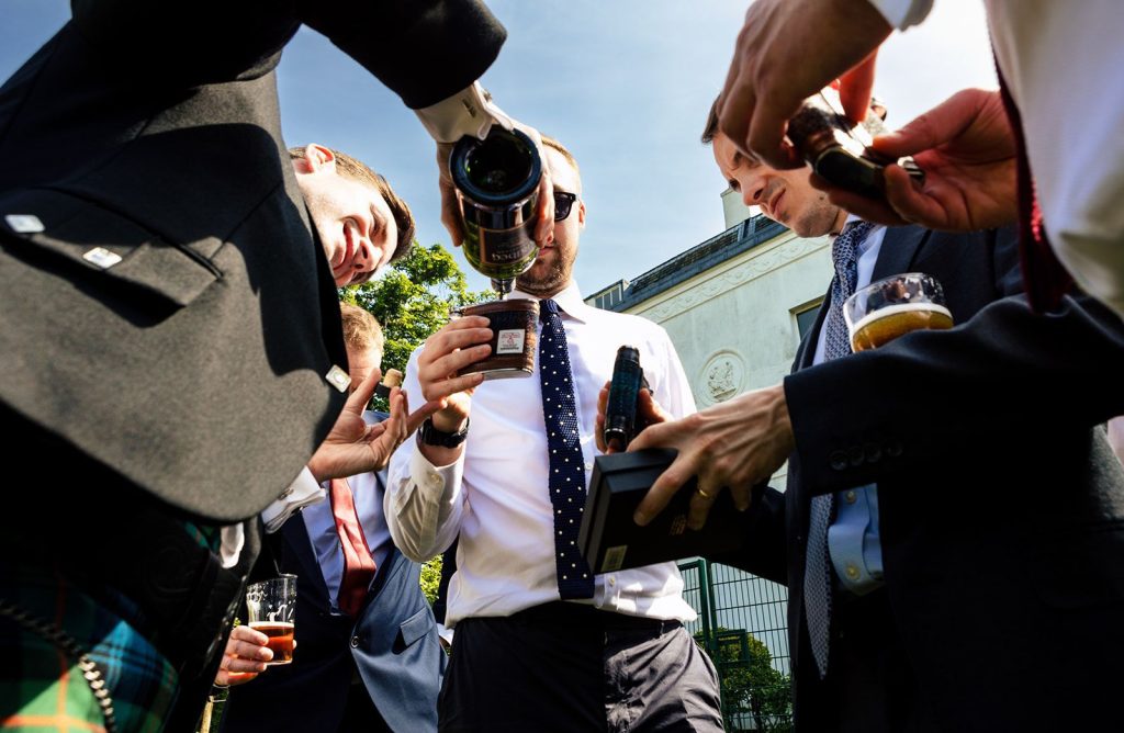 groom pouring whiskey